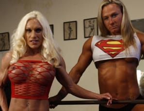 Bodybuilders Ashlee Chambers and Darkside Milinda start a super workout in the gym wearing panties, but soon they’re naked and posing, showing off their sexy pecs, big biceps and vascular, shredded abs and their tattoos, and bench pressing with their legs wide open, so they can see each other’s pretty kitties and so can you. Time for some super girl/girl for these women of steel?