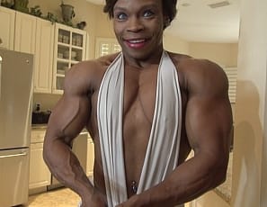 Female bodybuilder Nadia poses for you so you can get a good look at her ripped ebony abs, vascular biceps, and muscular pecs, legs, glutes and at her calves in clear high heels. I'm getting so turned on, she moans, as she masturbates her big clit with a toy. Aren't you?