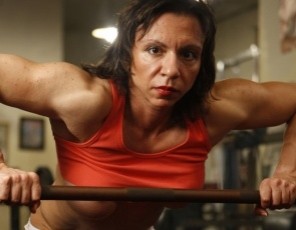 Female bodybuilder Alexis is posing and masturbating in the gym, showing off her big biceps and powerful pecs, her muscular abs, her strong legs and glutes, and her extra-big clit. You’ll see her pussy in close-up when she’s standing and on the leg press – and her ass, too.
