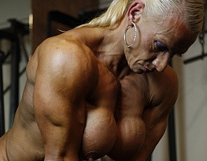 Bodybuilder Nicole Savage likes to work out in the gym in the nude and barefoot – a great way to check out her incredible definition and vascularity from every angle as she does bicep curls and poses, then stretches her glutes and legs and gives you a close-up look at her pierced and well-developed big clit.