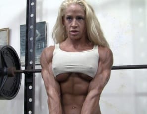 Professional female bodybuilder Jill Jaxen's in the gym, squatting in gold panties to work her muscular legs and glutes, and posing to show you her tattooed, vascular biceps, powerful pecs and ripped abs. Then she asks, Want to feel my quads? Well, do you?
