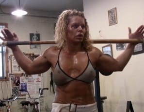 Female bodybuilder Michelle Falsetta  is posing for you in the gym,  sweating hard as she shows you her big, vascular biceps, her ripped abs,, muscular pecs,  delts, legs and glutes, and her tattoos. 
