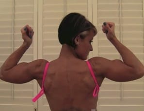 It's so hard! tattooed, ripped female bodybuilder Nikki exclaims as she poses and flexes her vascular biceps in the bedroom. Once you've looked at the massive muscles of her pecs, legs, glutes and abs, you'll probably be hard too.