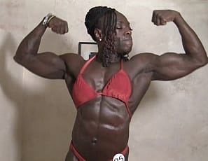 Ebony muscle goddess Roxanne Edwards is a sight to behold. Sharply defined abs, bulging biceps and powerful glutes and quads are always on display when Roxanne shows up. An imposing site gets even more imposing when Roxanne puts on her red posing suit. 