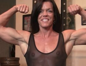 Tonya's mature biceps muscles are at their peak, as she shows you when she poses, flexes, and does naked pull-ups in the gym. Her legs, glutes and abs are impressively muscular, too. But take a peek as she rides a huge toy strapped to the bench and uses it on her big clit, and you'll see her pussy peak too as it's penetrated, in close-up.