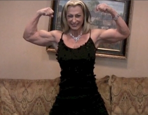 Mature female bodybuilder Gina Jones is posing for you in the bedroom, showing you how ripped and vascular she is, and pointing out all her hard muscles: her wide lats, her big pecs and biceps, her strong legs and glutes and her awesome abs. Now that you've met her, you won't forget her.