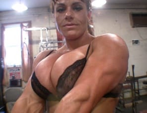 In the gym, ripped female bodybuilder Big Tinah poses for the camera and shows off her Amazonian biceps, ripped abs, and muscular legs and glutes. Then she bench presses in sheer panties, to develop her vascular pecs even more. It feels so good, she just has to fondle the best chest in the room.
