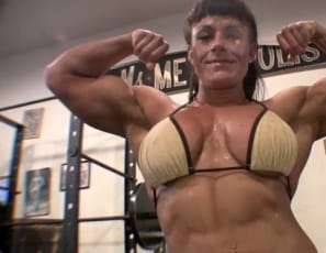 Bodybuilder Big Tinah poses for you in this video from the SheMuscle gym to show off her big, beautiful 16” biceps, caressing them as she goes, then grabs a dumbbell to pump up and get even more vascular. While she’s touching herself, she pulls aside her bikini top for a pec massage. 
