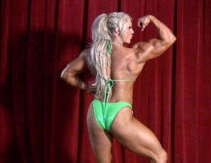 Bodybuilder Lisa Cross poses on stage, displaying her incredible musculature, but your first clue that this isn’t a standard competition is when she takes off her bikini top and bottom so she’s completely nude. Then she starts masturbating, squeezing and spanking her big clit in video close-up. We bet the judges were pleased. Aren’t you?