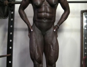 “Apparently domination is still the name of the game,” female bodybuilder Roxanne Edwards says as she poses in the gym. She’s nude. Her huge muscles are ebony, bulging and vascular, her abs are ultra-ripped, and her pecs,  legs, glutes, calves and biceps show she’s right. Because she could definitely dominate you. Or just about anyone.